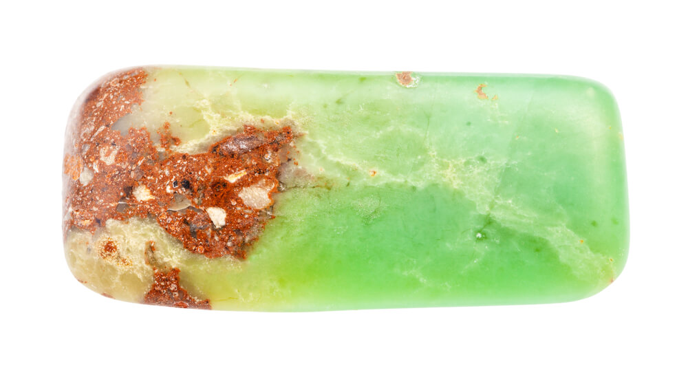 A green crystal with brown at the end.