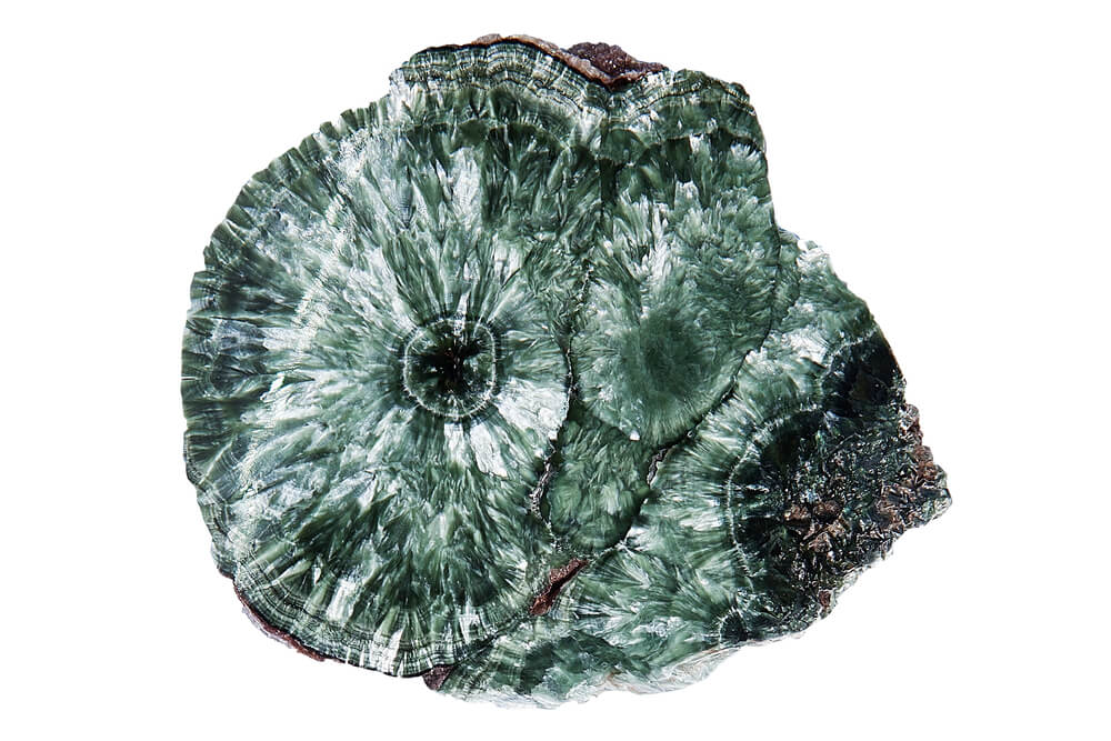 A green stone with white and black on it.