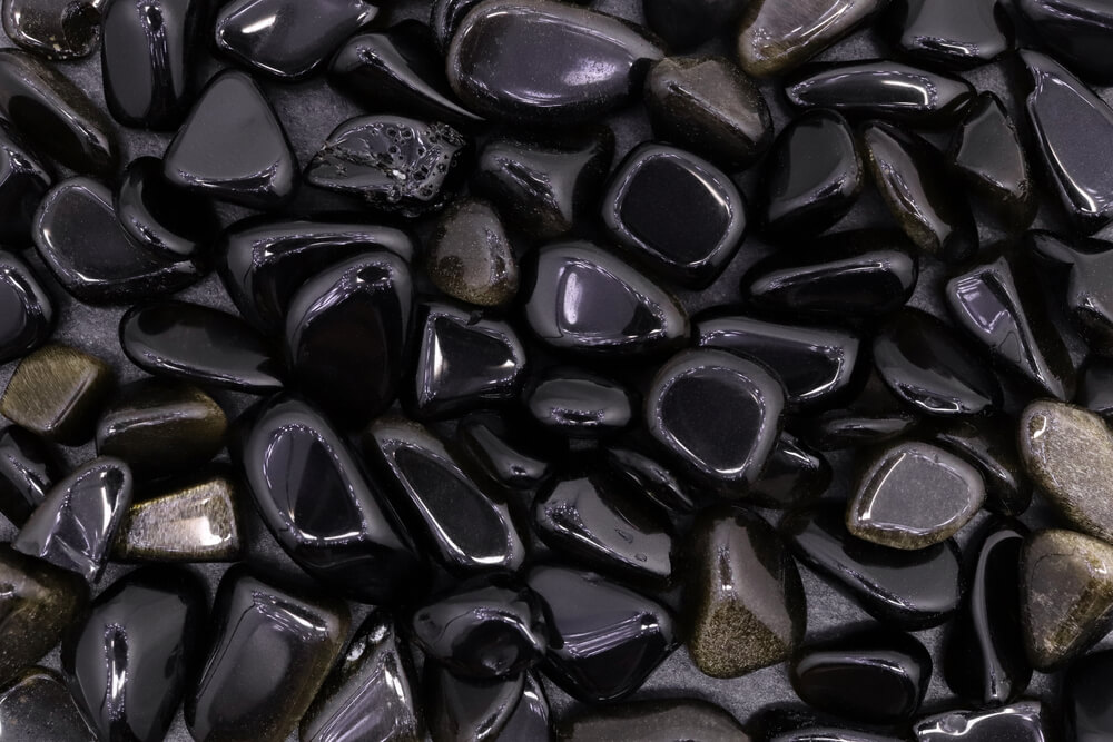 A bunch of polished black gemstones.