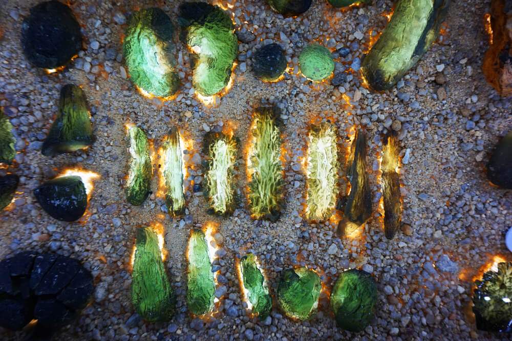 A collection of green glassy-looking rocks.