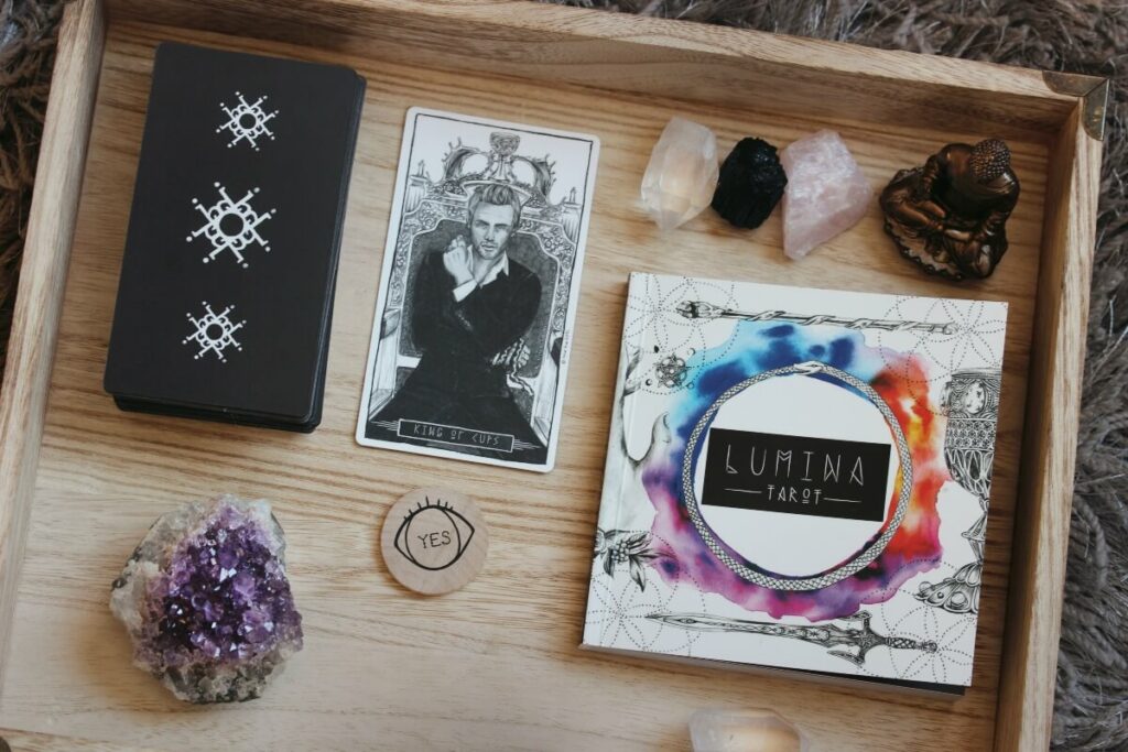 A tray with crystals and books on it.